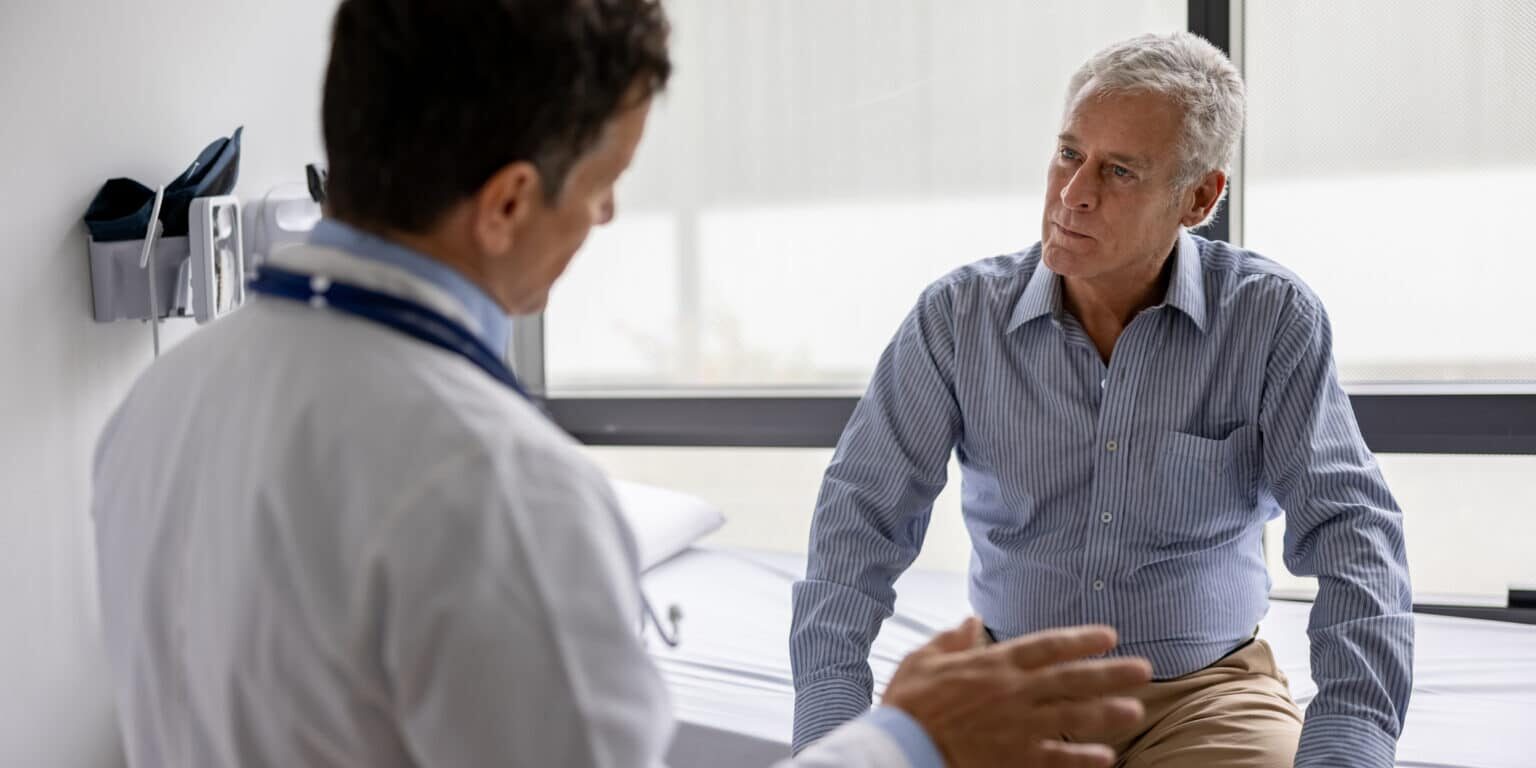 Doctor talking to a patient in a consultaton at the office Challenges and Solutions in Pediatric ENT Care